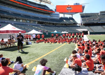 Anthony addressing campers on the field during Football Academy 2022