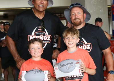Anthony and coach with campers named Most Valuable Persons (MVPs) at Football Academy 2022