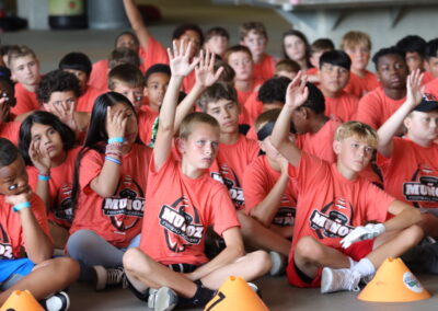 Campers raising their hands at Football Academy 2022