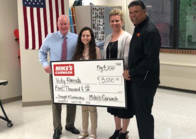 Anthony, Mike Dahm and Bethany McAllister of Mike's Carwash, and 2021 Straight 'A' Scholarship Overall Female Student of the Year Vicky Almeida
